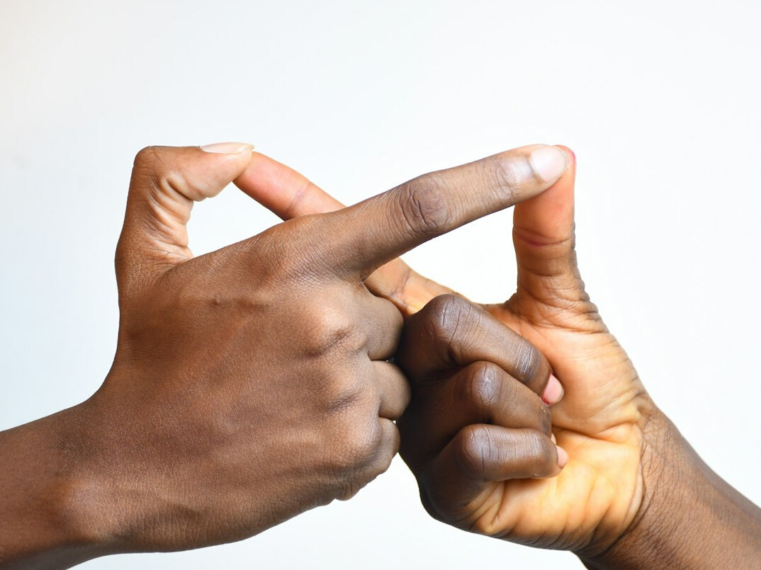Two business people shaking hands in an office meeting