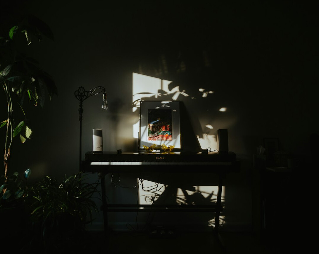 Editor retouching photographs on a laptop and monitor